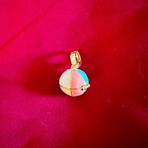 Beach ball opens with a little sun charm with crystal in the center